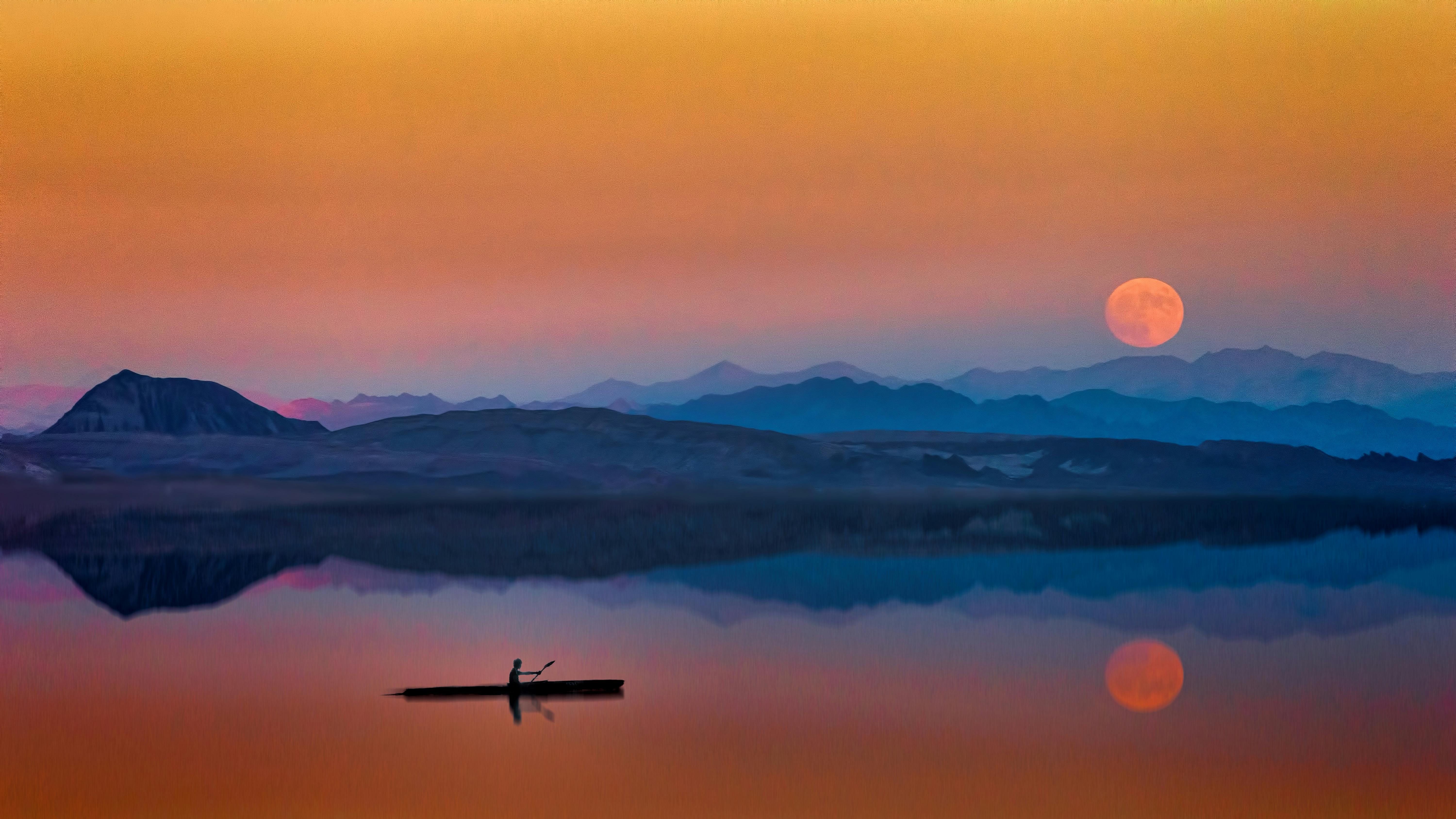 Full moon rising over mountains and reflected in water